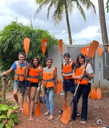 Click here for Sweet Earth Goa Guide Chapora river. Group wearing life jackets and holding paddles before a kayaking tour.